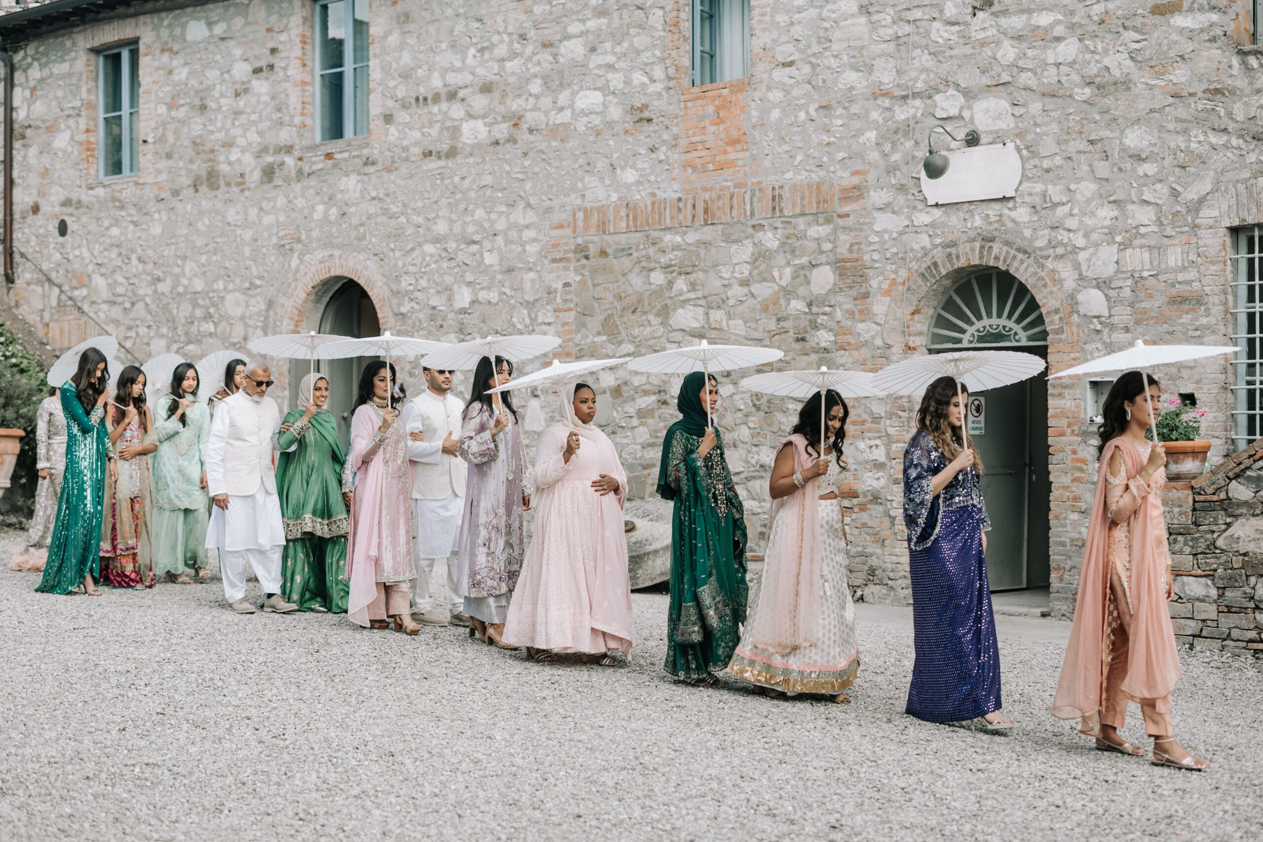 Wedding guests with ombrellas for the sun