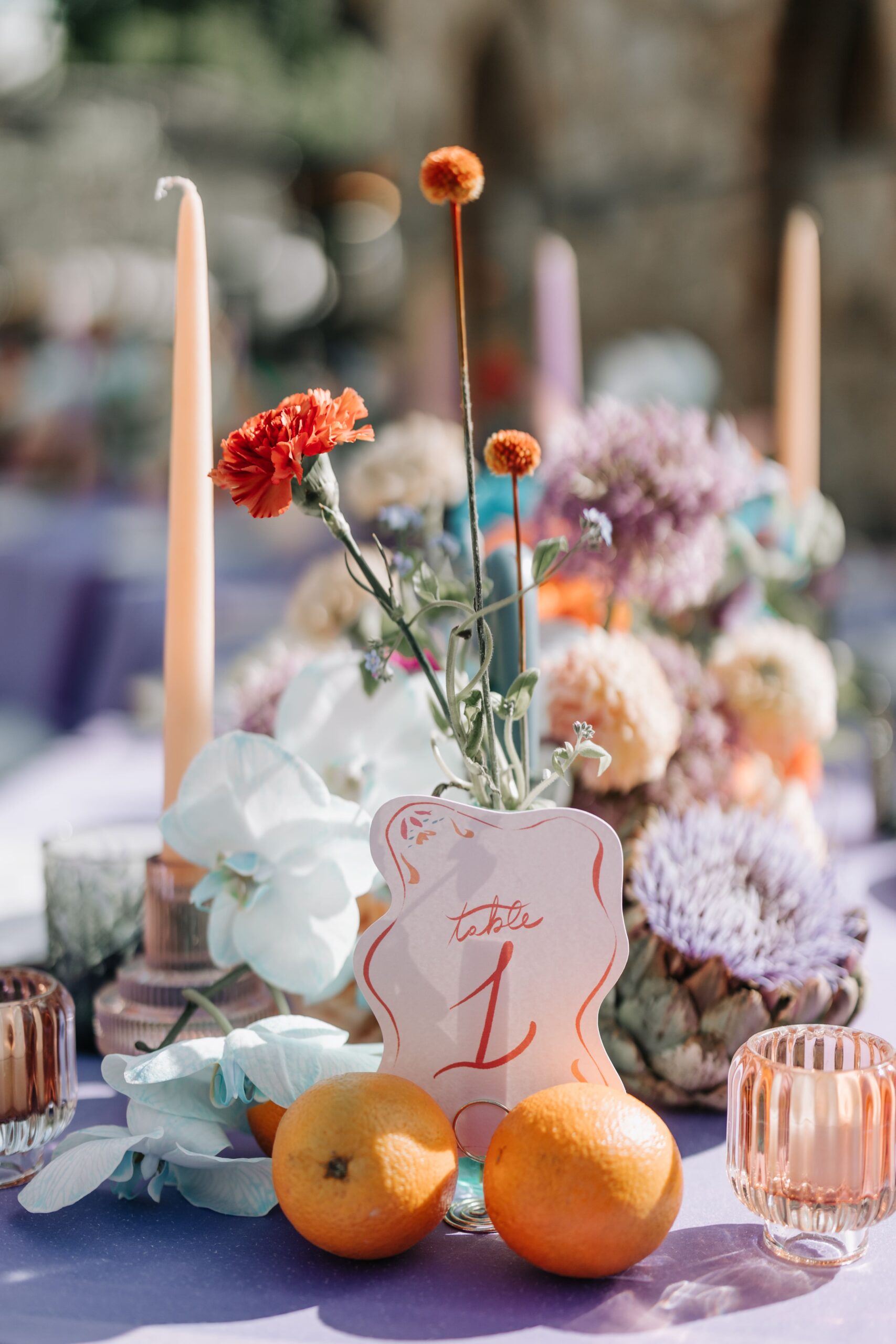 A centerpiece with flowers and candles